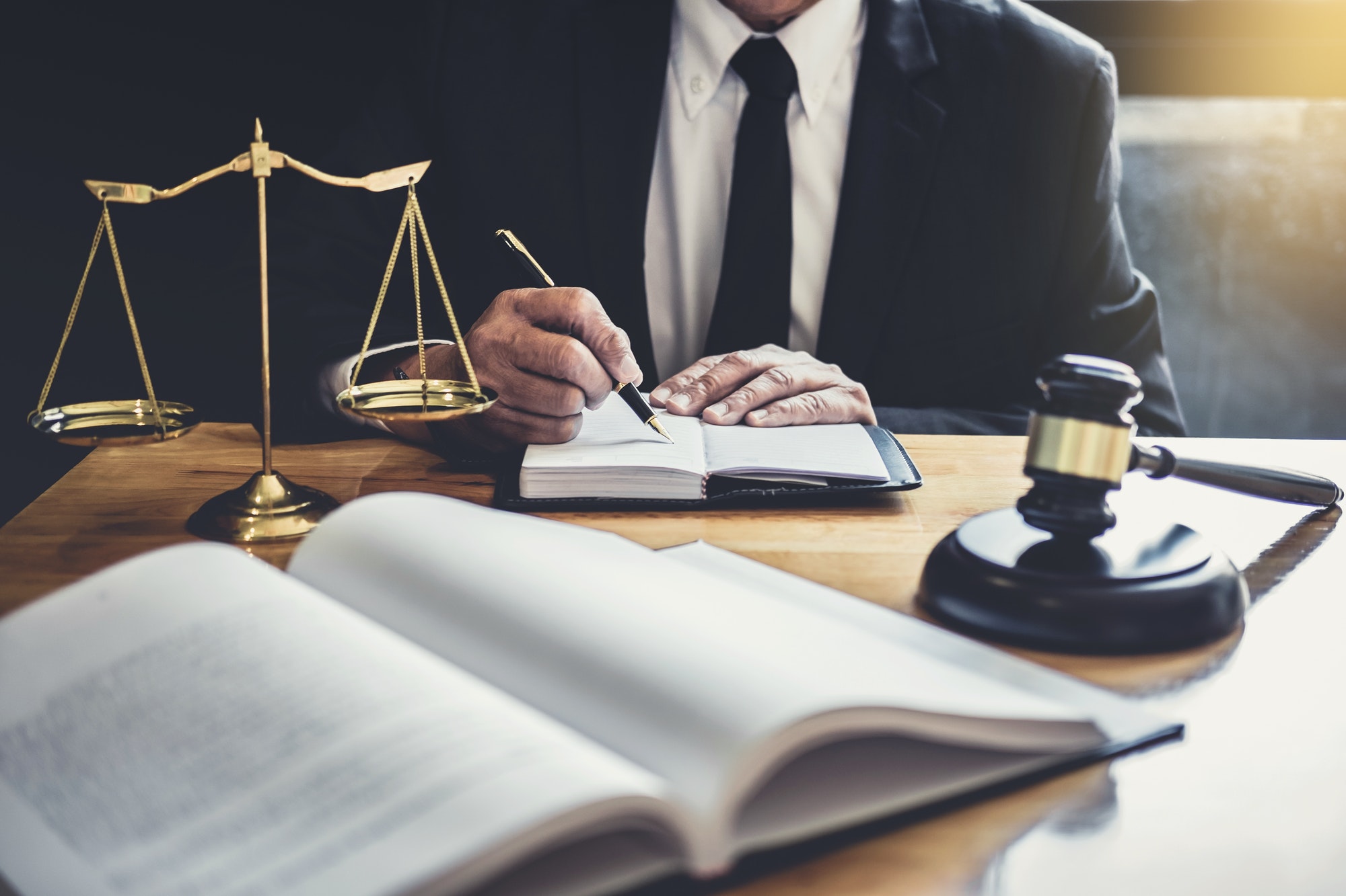male-lawyer-or-judge-working-with-contract-papers.jpg